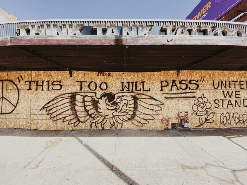 Wooden art with text, "This too will pass"