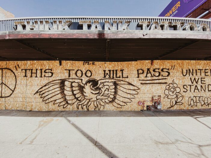 Wooden art with text, "This too will pass"