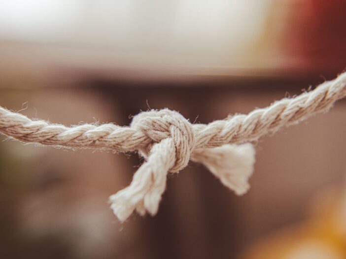 Three intertwined rope strands tied together, symbolizing the meaning of “a threefold cord is not easily broken” in Ecclesiastes 4:12.