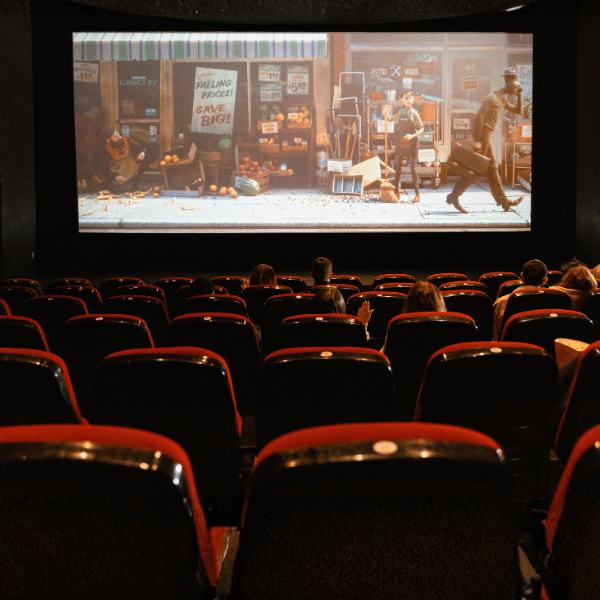 Movie playing in the theaters with a few audience watching