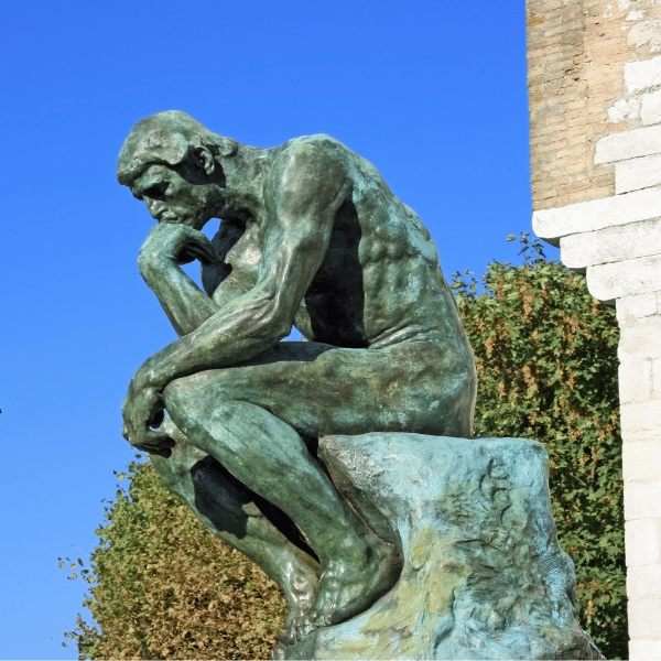 Sculpture of a thinker with hand on chin