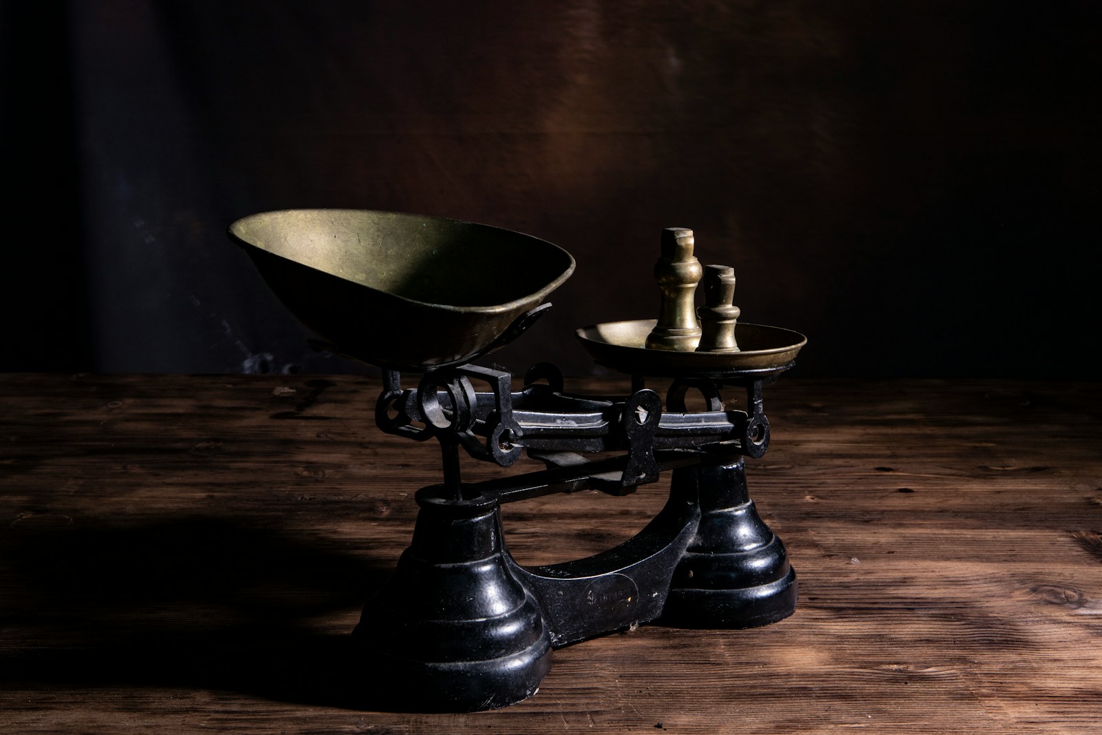 Antique balance scale with uneven weights, illustrating the idea of suicidal empathy and the balance between compassion, judgment, and consequences.