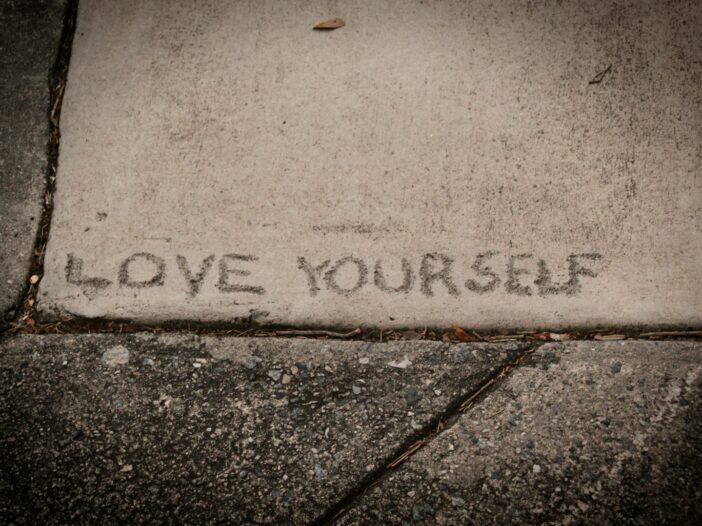 short self-love text on concrete