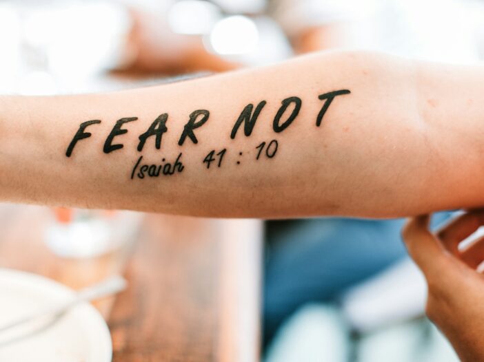 person with fear not tattoo from the Bible verse Isaiah 41:10 on arm