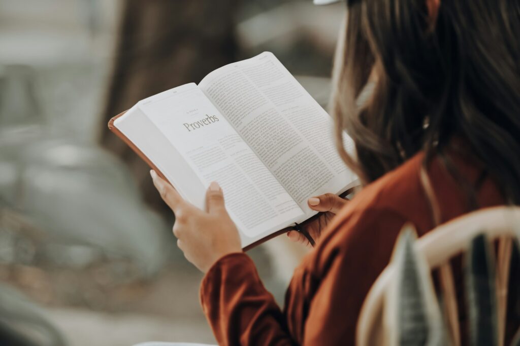 Woman reading the Bible, finding encouraging bible verses for hard times