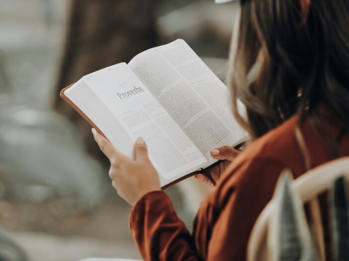 Woman reading the Bible, finding encouraging bible verses for hard times