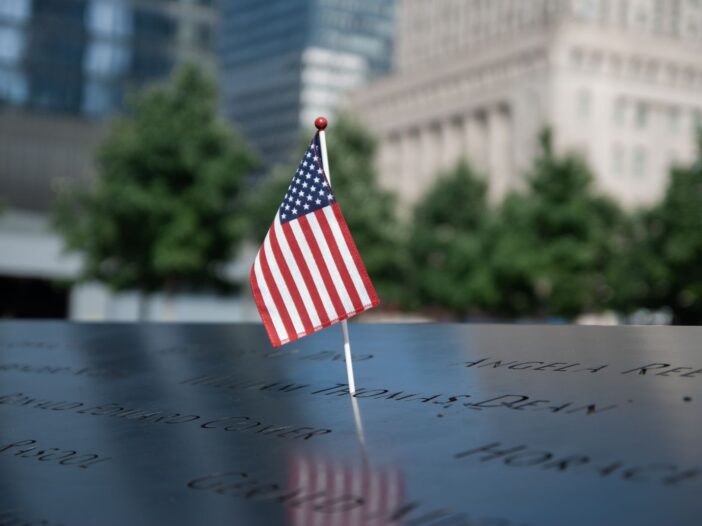 American flag at the September 11 Memorial in NYC, symbolizing remembrance and patriotism.