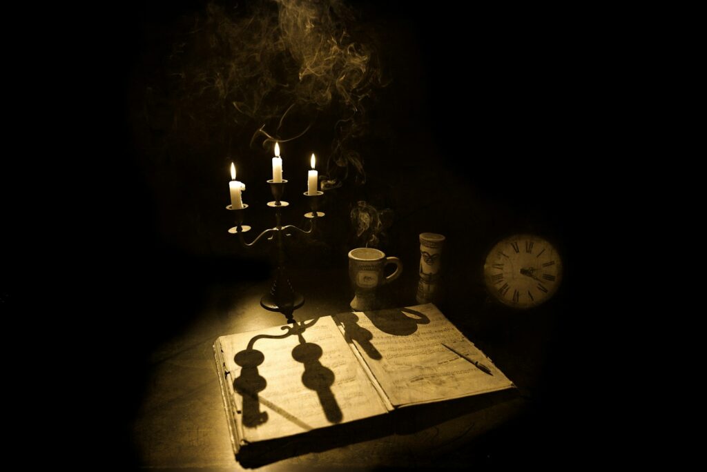 Halloween quotes from literature represented by an antique book, candles, smoke, and clock.