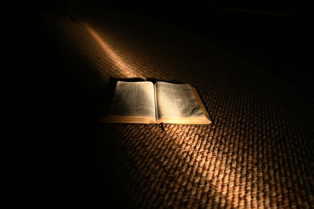 C.S. Lewis The Problem of Pain represented by an open book illuminated in darkness