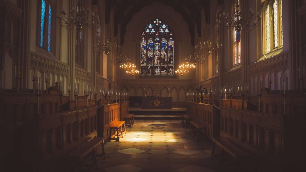 oody cathedral interior with stained glass for a God is dead Nietzsche article