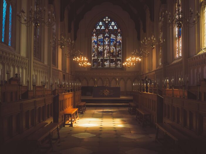 oody cathedral interior with stained glass for a God is dead Nietzsche article