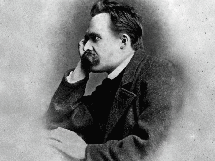 Black-and-white portrait of Friedrich Nietzsche seated with his head resting on his hand