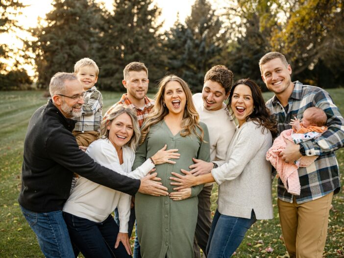 Multigenerational family laughing together outdoors, reflecting the love celebrated in family quotes from books.