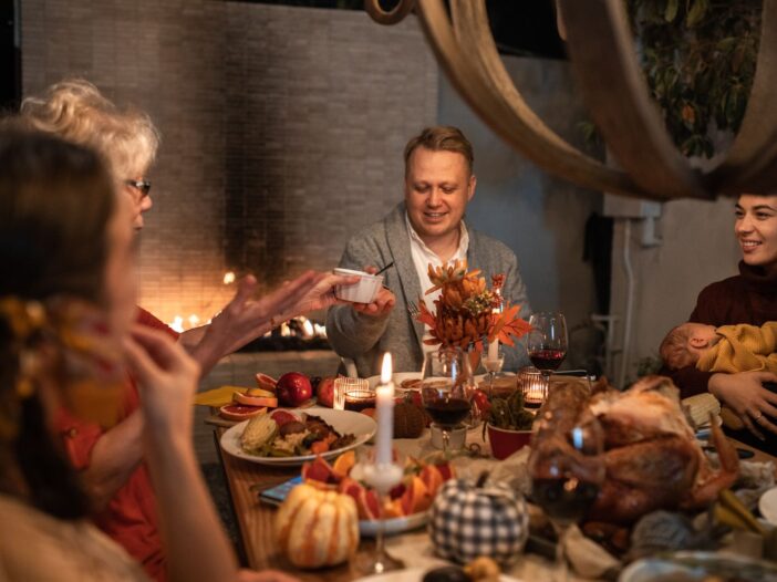 Family gathered around a festive Thanksgiving dinner, illustrating the true meaning of Thanksgiving.
