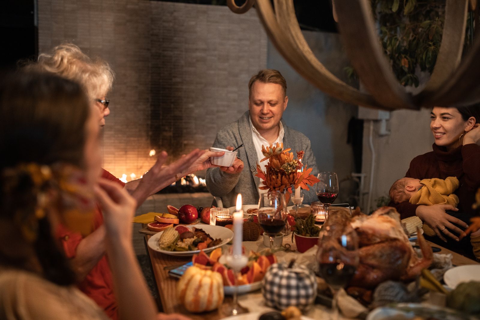 Family gathered around a festive Thanksgiving dinner, illustrating the true meaning of Thanksgiving.