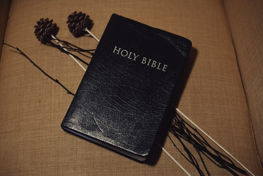 Black bible sitting on top of a couch