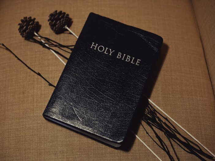 Black bible sitting on top of a couch