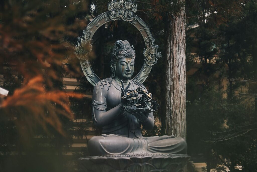 Buddha statue surrounded by nature, representing Buddha quotes about life and peace