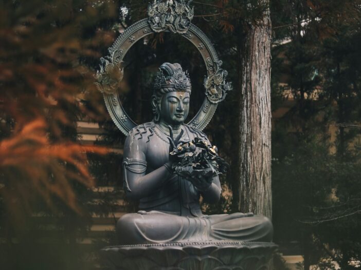 Buddha statue surrounded by nature, representing Buddha quotes about life and peace