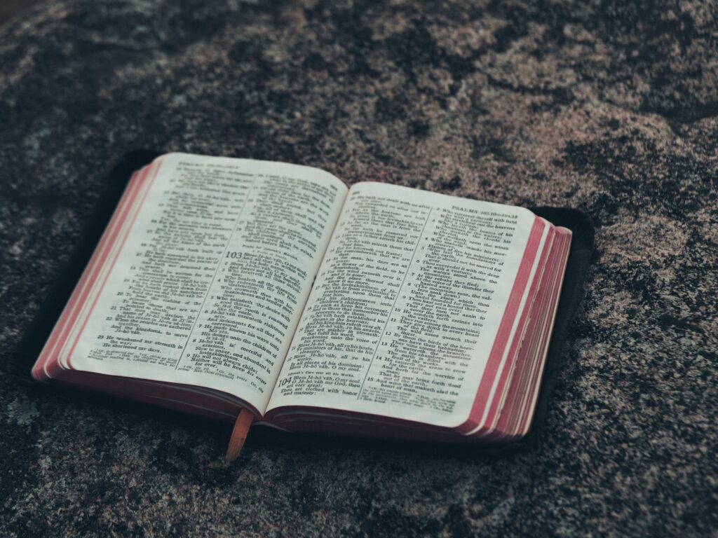 Open bible with verses set on marble top