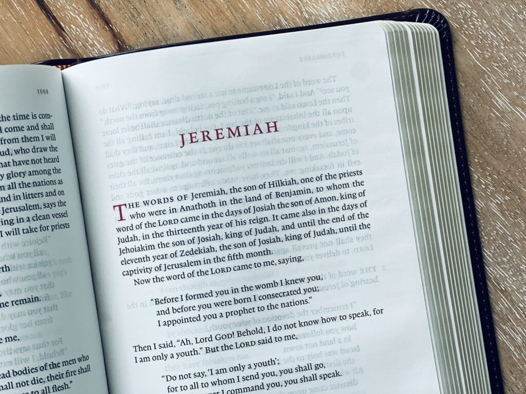 The book of jeremiah is wide open and displayed.