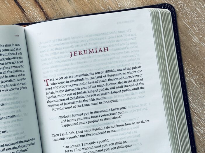 The book of jeremiah is wide open and displayed.